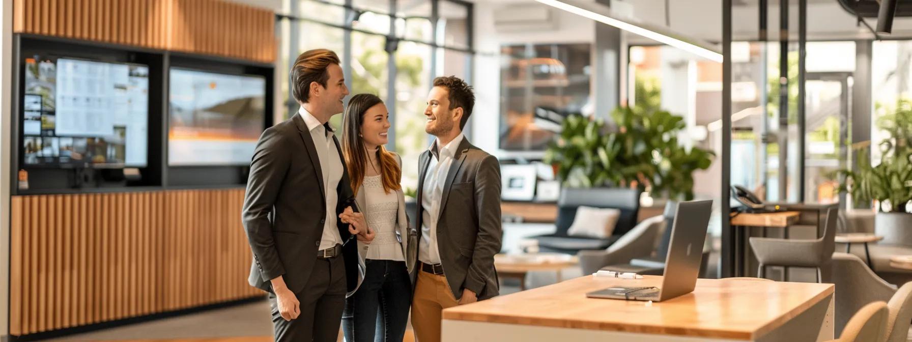 a professional buyers agent confidently guides a couple through a sleek brisbane office filled with property listings and digital displays, illustrating the streamlined and expert support in navigating the local real estate market.