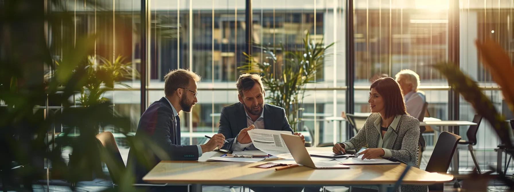 Group of professionals discussing property investment strategies in a modern office setting, with documents and a laptop on the table, surrounded by plants and natural light.