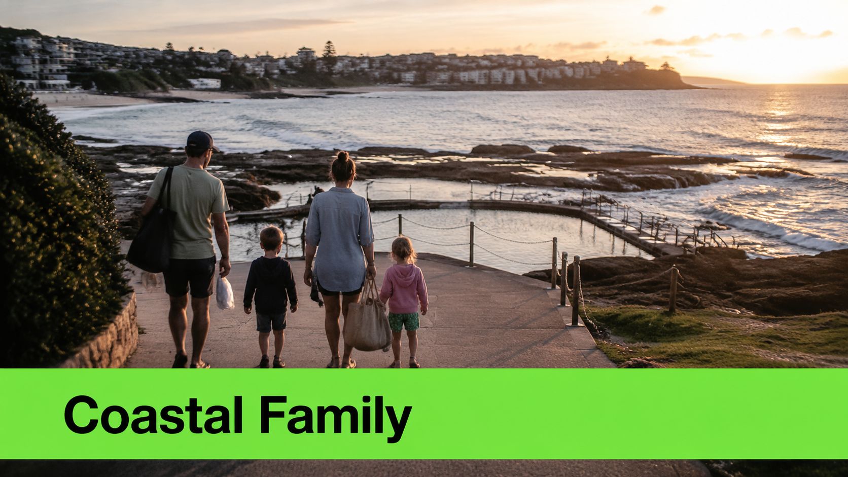 A family of four walking down a path towards a coastal rock swimming pool at sunset.